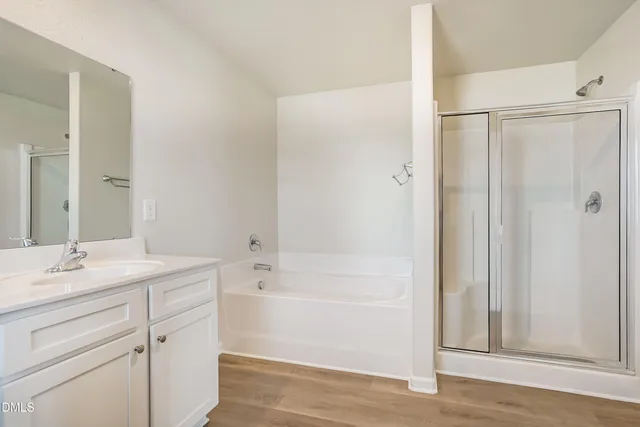 a bathroom with a granite countertop sink a toilet and shower