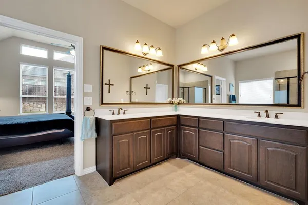 a spacious bathroom with a sink double vanity and a mirror