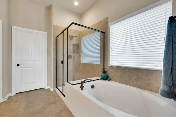 a bathroom with a bathtub and shower