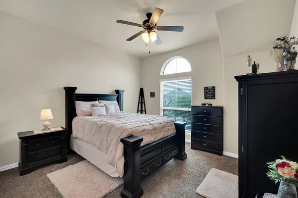 a bedroom with a bed and a chandelier