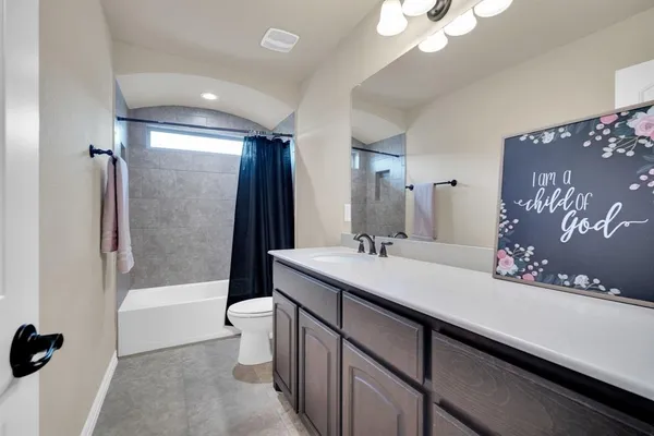 a bathroom with a sink a toilet and a large mirror