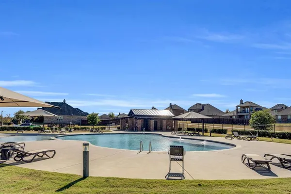 a view of a swimming pool with seating area and furniture