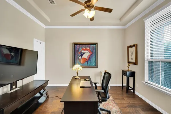 a work room with furniture and a flat screen tv