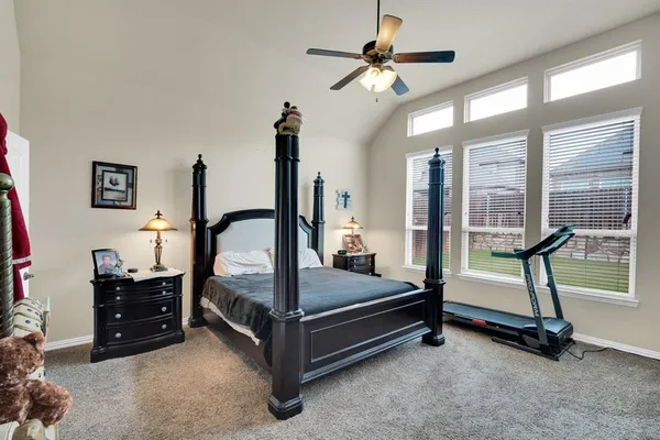 a bedroom with double bunk beds and a ceiling fan