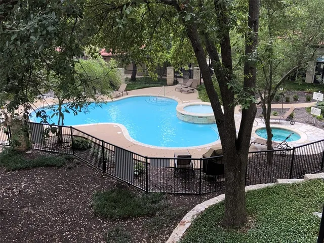 a view of a backyard with table and chairs plants and trees