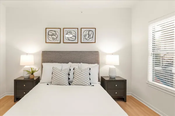 a bedroom with a bed and a night stand