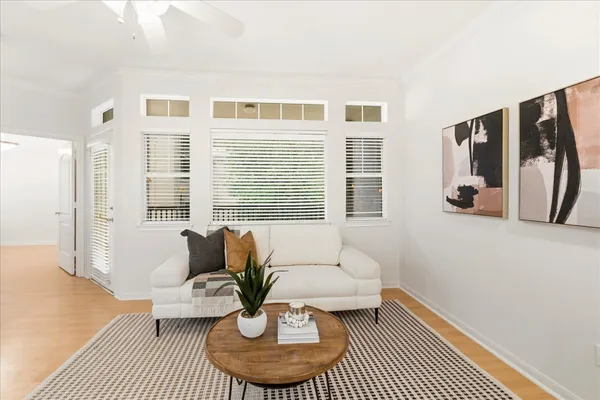 a living room with furniture and wooden floor