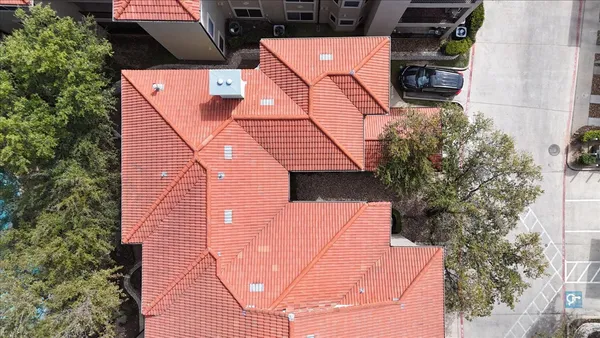 an aerial view of a house with garden space and street view