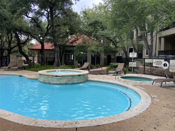 a view of a swimming pool with a patio