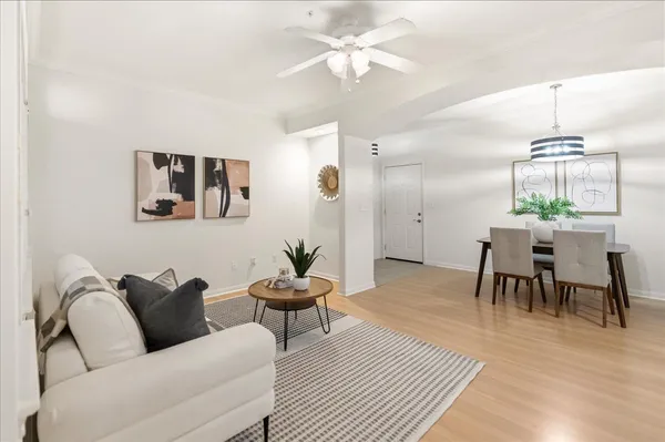a living room with furniture and a wooden floor