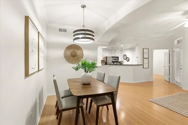 a view of a dining room with furniture wooden floor and chandelier