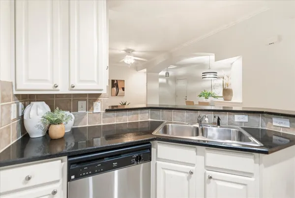 a kitchen with kitchen island a sink and cabinets