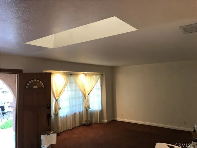 a room with pool table and windows