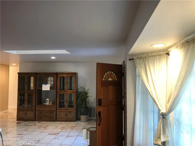 a kitchen with stainless steel appliances kitchen island granite countertop a refrigerator a stove a sink dishwasher and a dining table with wooden floor