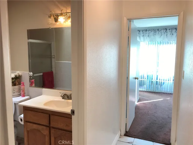a bathroom with a tub sink and mirror
