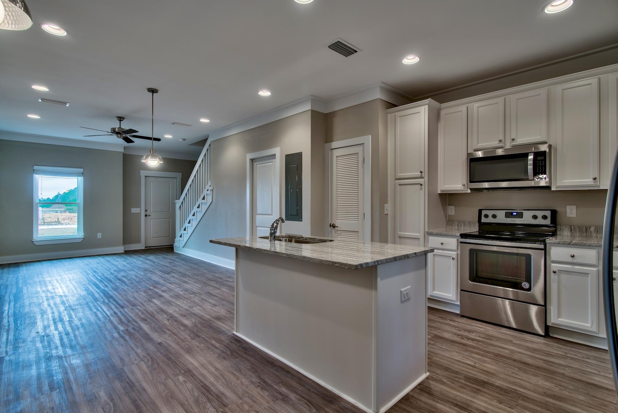 50 South Sand Palm Road, Unit LOT 41 Freeport, FL 32439 - Photo 8 of 20 a large kitchen with stainless steel appliances kitchen island granite countertop a stove a sink and a refrigerator