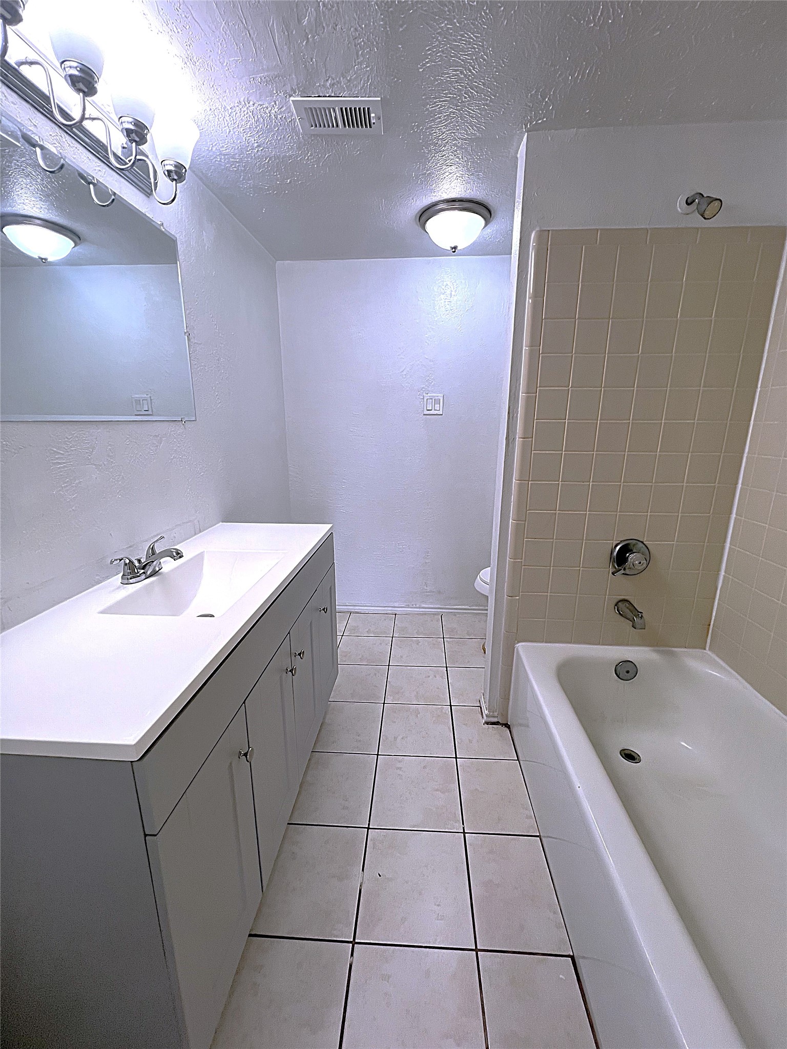 19906 Rising Star Drive Humble, TX 77338 - Photo 7 of 32 a spacious bathroom with a bathtub sink and mirror