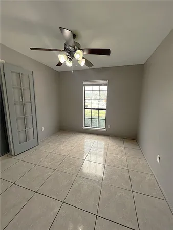 a view of a hallway with windows and chandelier
