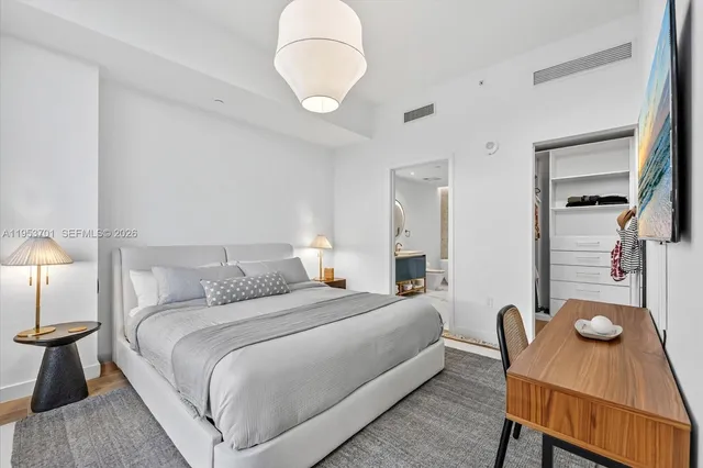 a bathroom with a toilet a double vanity sink and a mirror