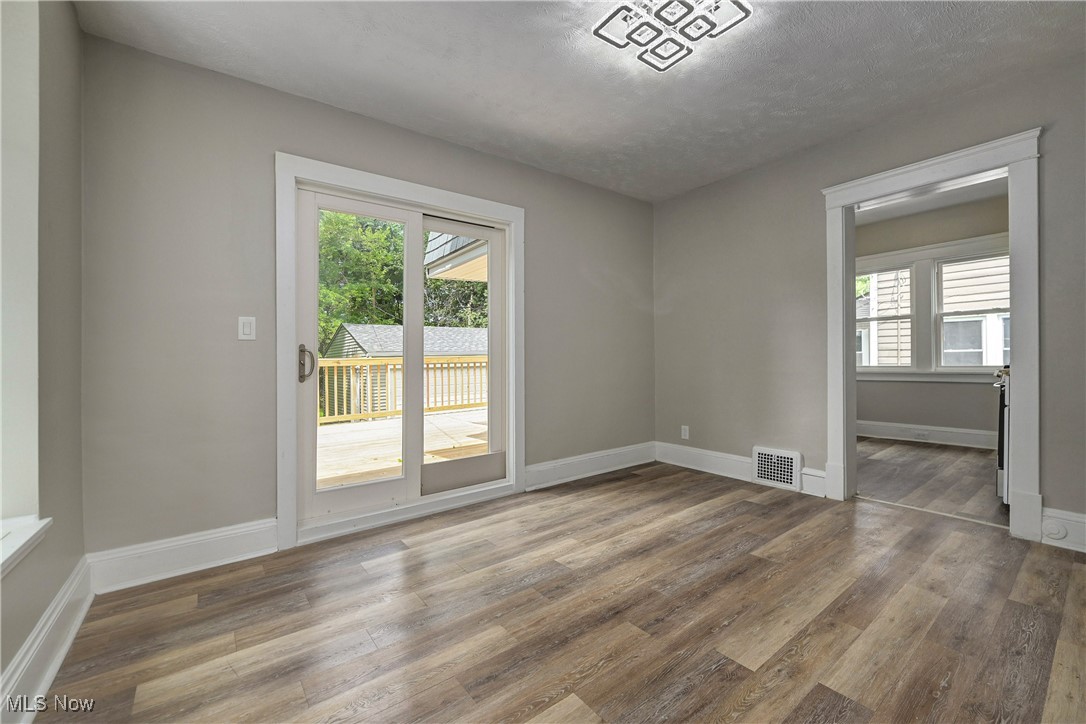 896 Selwyn Road Cleveland Heights, OH 44112 - Photo 6 of 23 Empty room with healthy amount of natural light and wood finished floors