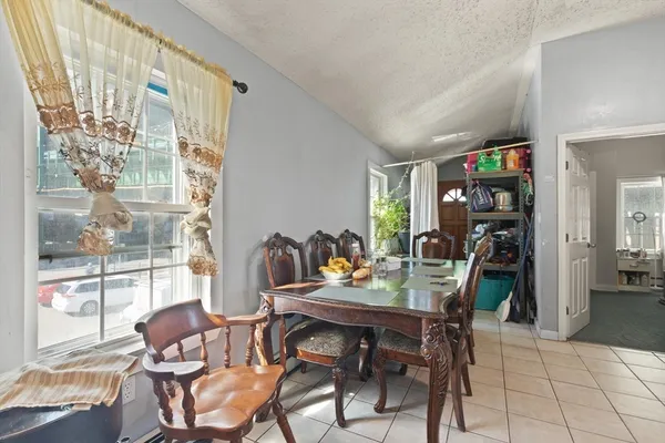 a dining room with furniture and a floor to ceiling window