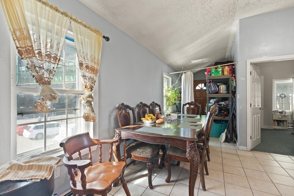 74 Chestnut Street Chelsea, MA 02150 - Photo 11 of 37 a dining room with furniture and a floor to ceiling window
