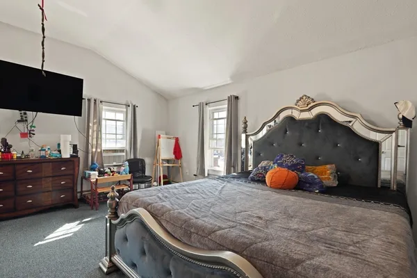 a bed room with a bed and a chair