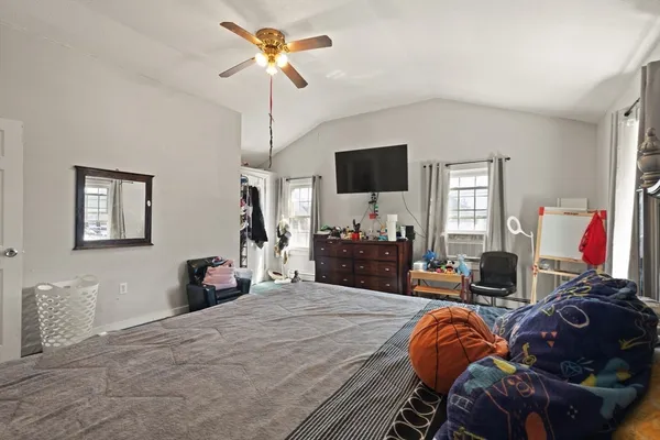 a bedroom with a bed and a flat screen tv