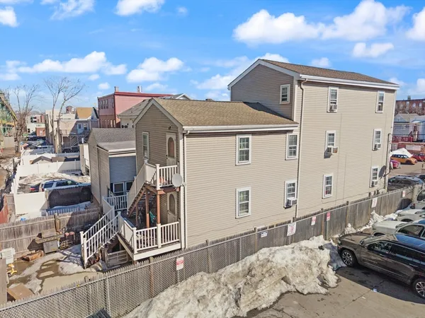 a view of a house with a snow in the background