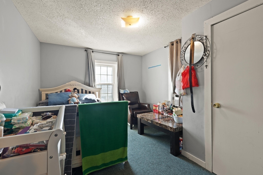 74 Chestnut Street Chelsea, MA 02150 - Photo 22 of 37 a bedroom with a bed and a window