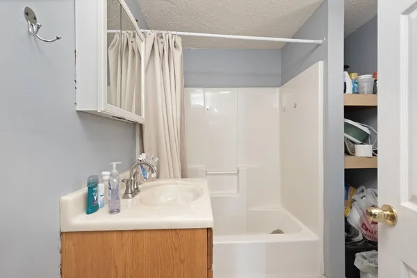 a bathroom with a sink vanity and a mirror