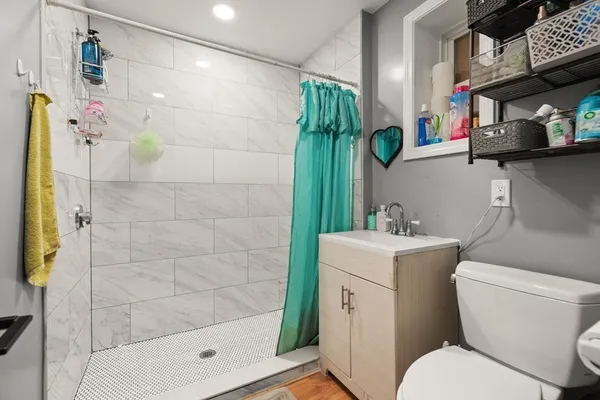a bathroom with a sink toilet and shower