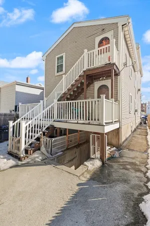 a view of a house with a wooden deck