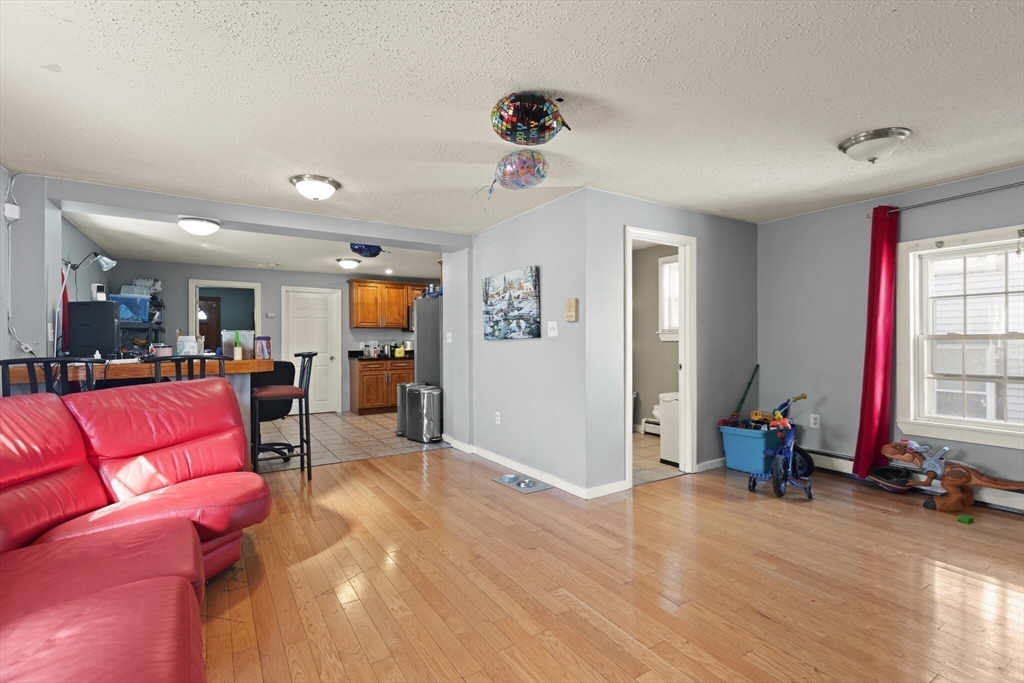 74 Chestnut Street Chelsea, MA 02150 - Photo 3 of 37 a living room with furniture and a flat screen tv