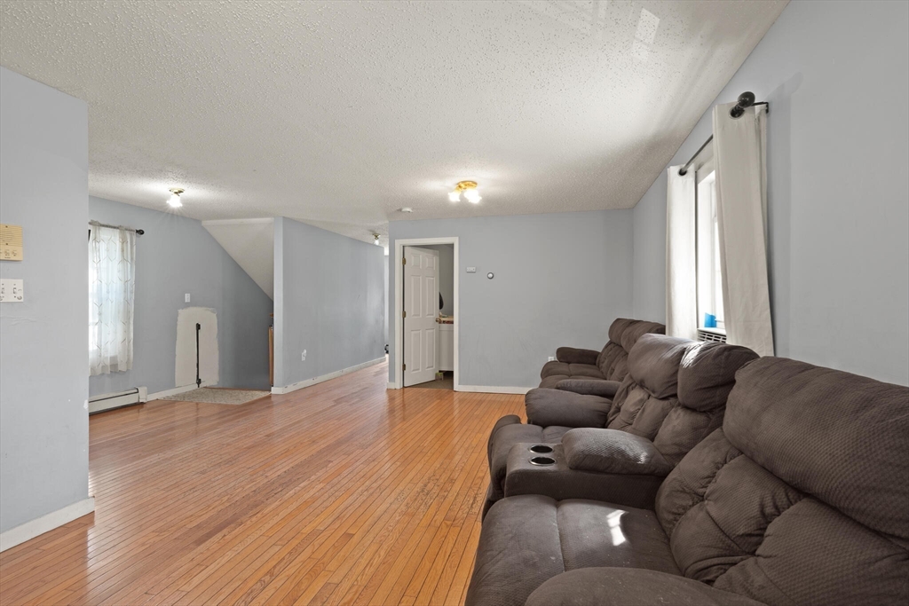 74 Chestnut Street Chelsea, MA 02150 - Photo 7 of 37 a living room with furniture and a couch
