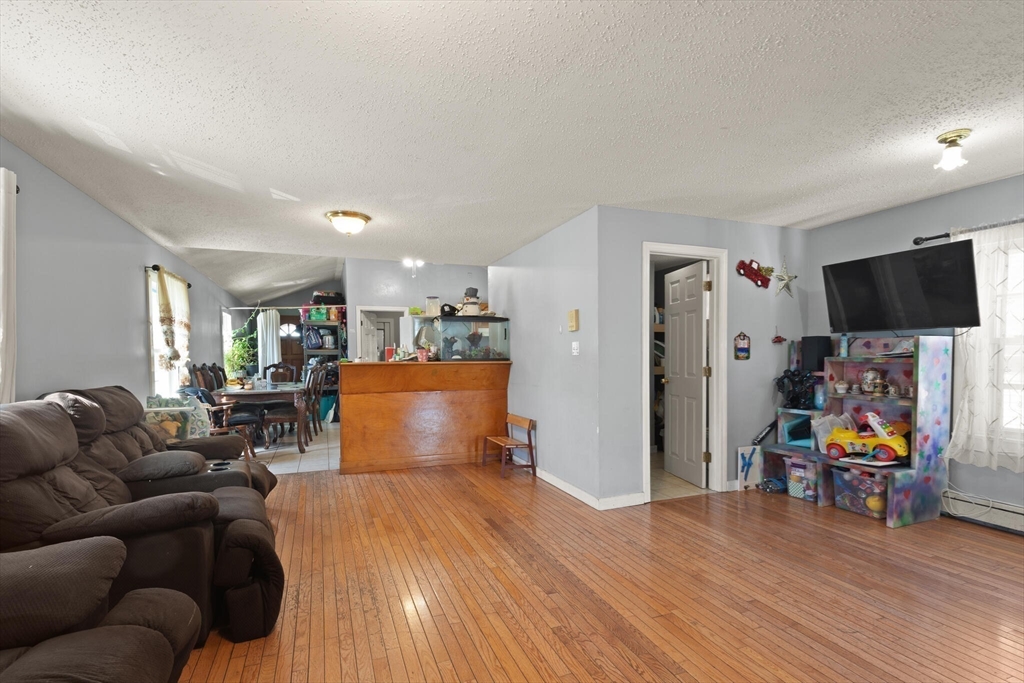 74 Chestnut Street Chelsea, MA 02150 - Photo 10 of 37 a living room with furniture and a flat screen tv
