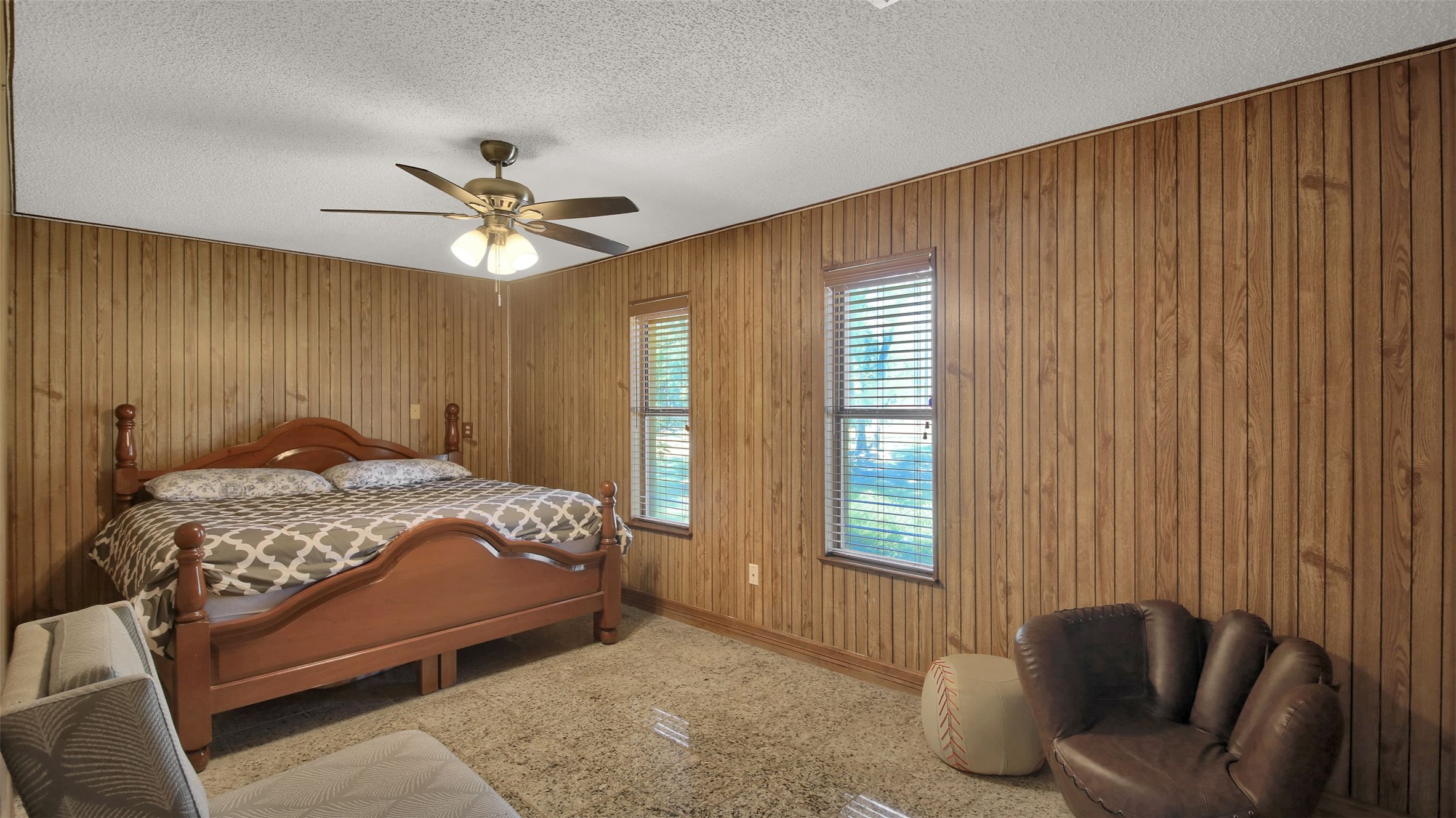 191 Jordan Lane Elgin, TX 78621 - Photo 10 of 29 Rich wood paneling lines the walls of this cozy bedroom with soft carpet flooring.