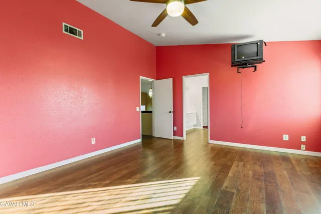 a view of a livingroom with a ceiling fan and window