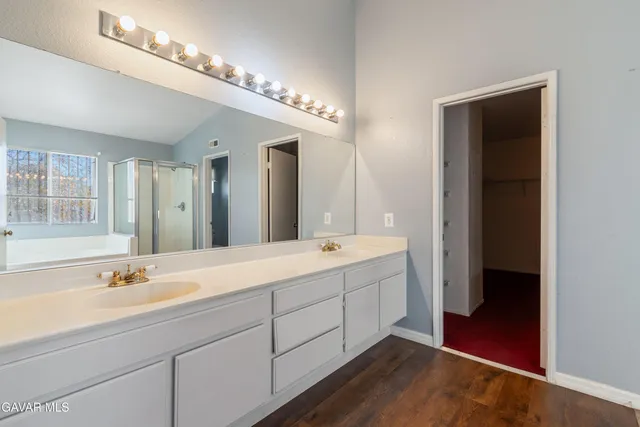 a spacious bathroom with a double vanity sink and a mirror