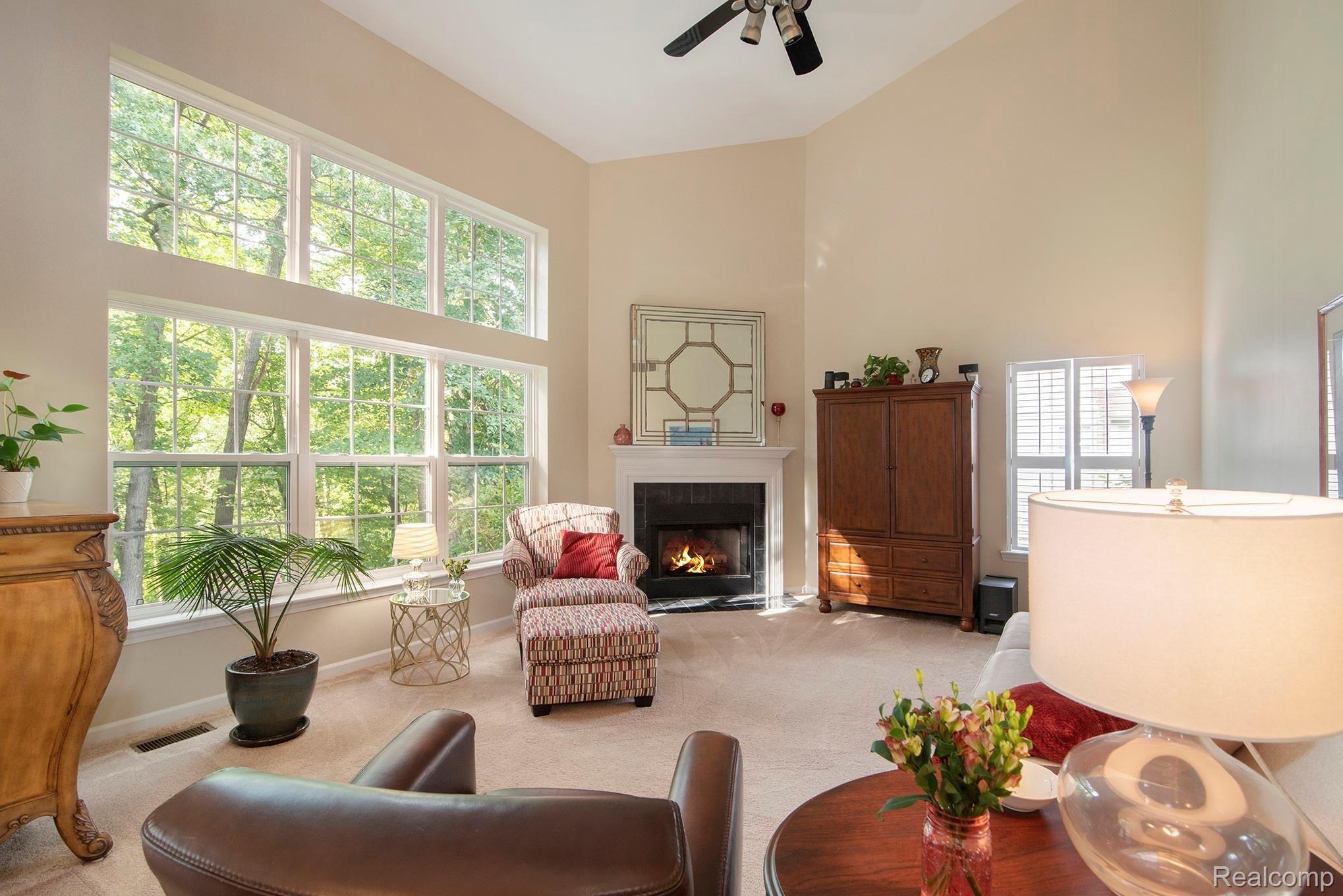 2524 Ravine Side North Howell, MI 48843 - Photo 14 of 31 Large family room with gas fireplace, huge windows, and vaulted ceiling