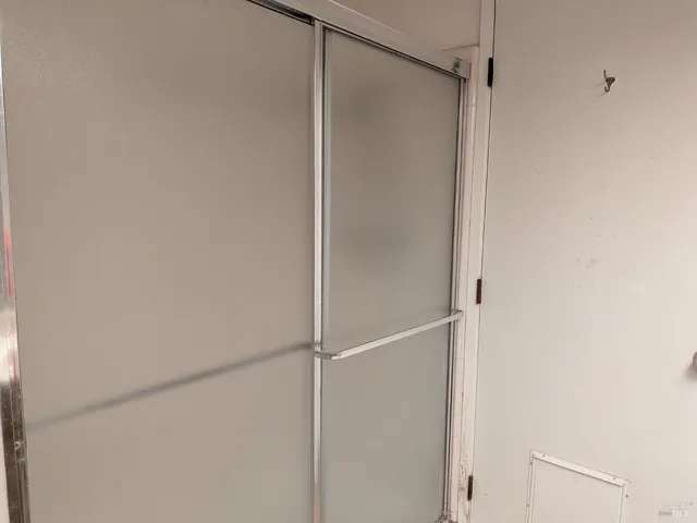 a bathroom with a glass shower door