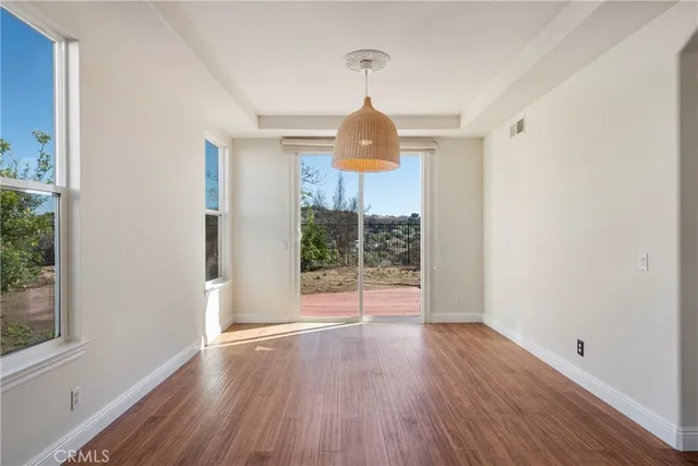 a spacious bathroom with a granite countertop sink a mirror and a bathtub