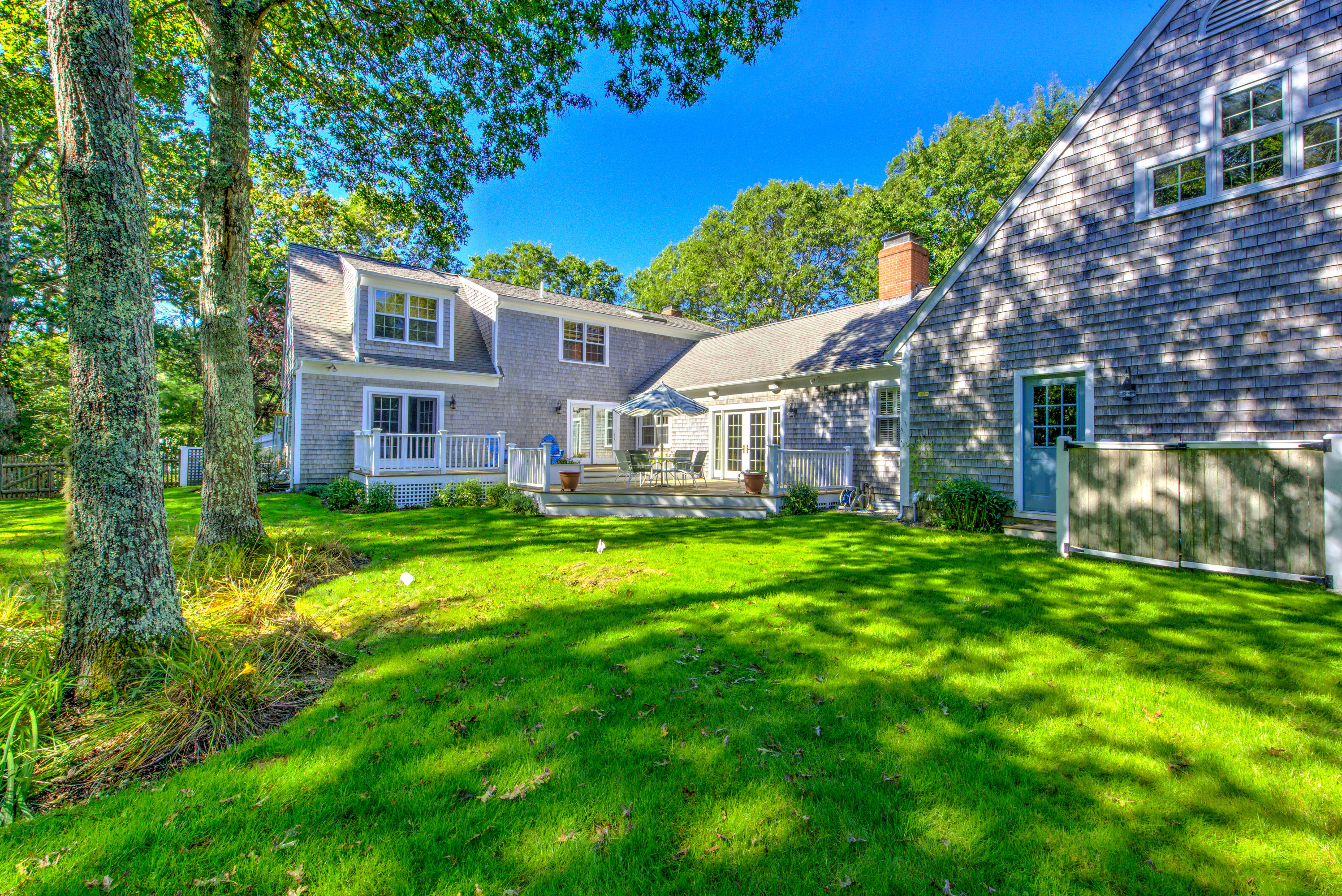 48 Crystal Ridge Road Marstons Mills, MA 02648 - Photo 23 of 26 a front view of a house with a yard table and chairs