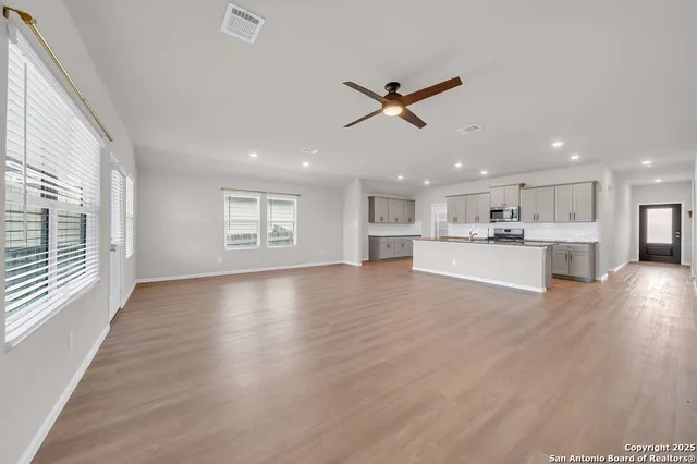 a view of a kitchen with a sink and wooden floor