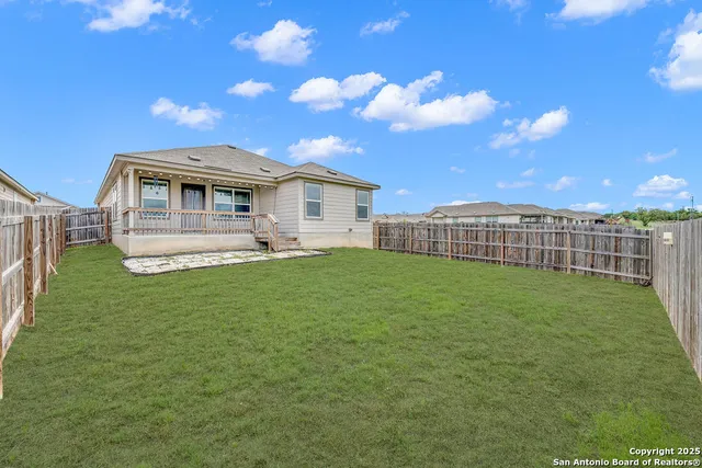 a view of a house with a yard and sitting area