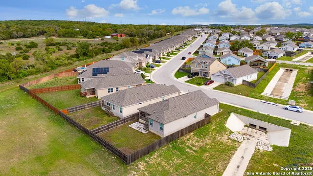 an aerial view of residential houses with outdoor space