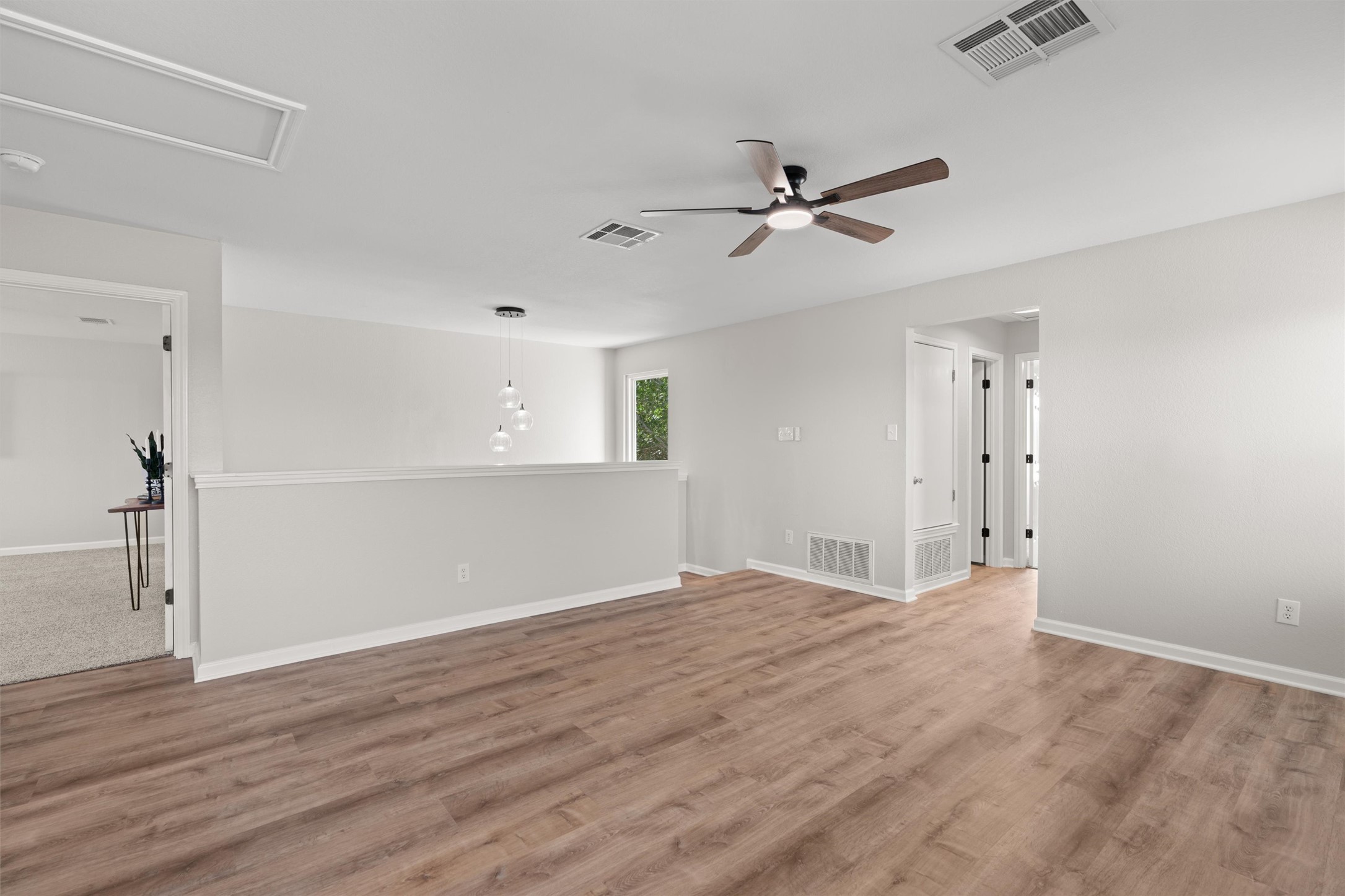 724 Lavaca Loop Elgin, TX 78621 - Photo 25 of 40 Smooth wood-style flooring runs throughout this versatile second-floor loft space.