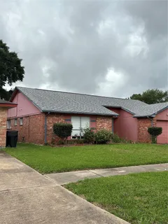 a view of a house with a yard and potted plants