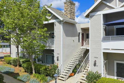 a front view of a house with plants