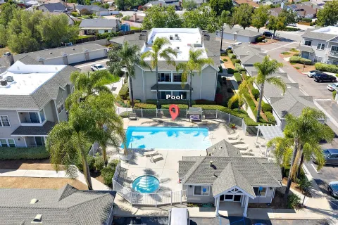 an aerial view of multiple houses with yard